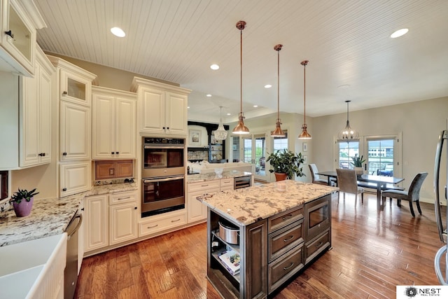 820 N 100th St, Lincoln, NE 68527 - kitchen featuring appliances with stainless steel finishes, dark brown cabinetry, wine cooler, hardwood / wood-style flooring, and light stone countertops