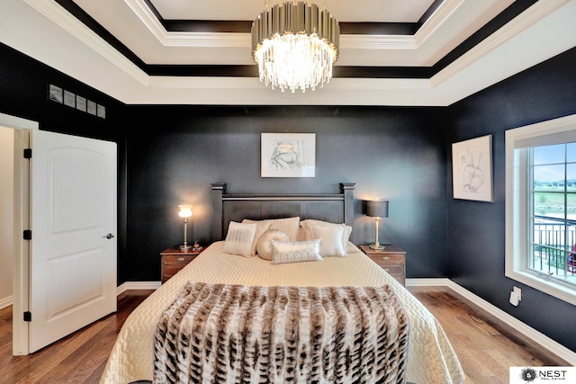 820 N 100th St, Lincoln, NE 68527 - bedroom featuring wood finished floors, a chandelier, crown molding, and a tray ceiling