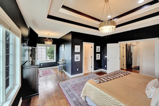 820 N 100th St, Lincoln, NE 68527 - bedroom with a chandelier, crown molding, a tray ceiling, and hardwood / wood-style flooring