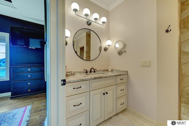 820 N 100th St, Lincoln, NE 68527 - bathroom with crown molding, vanity, and wood finished floors