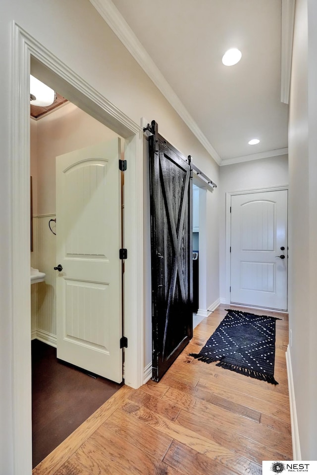 820 N 100th St, Lincoln, NE 68527 - entrance foyer with a barn door, wood finished floors, crown molding, and recessed lighting