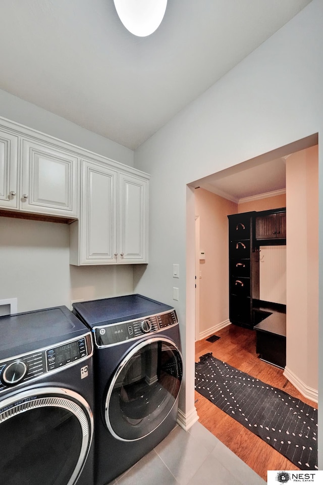 820 N 100th St, Lincoln, NE 68527 - laundry room with separate washer and dryer, cabinet space, and wood finished floors