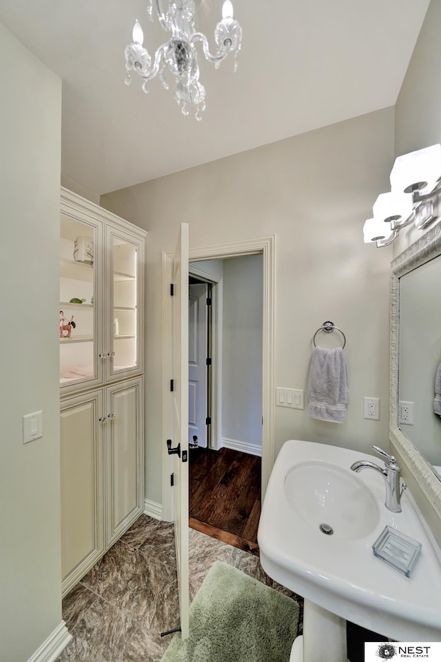 820 N 100th St, Lincoln, NE 68527 - bathroom featuring a chandelier and marble look tiles