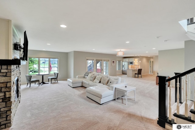 820 N 100th St, Lincoln, NE 68527 - living area featuring light colored carpet, recessed lighting, healthy amount of natural light, and stairs