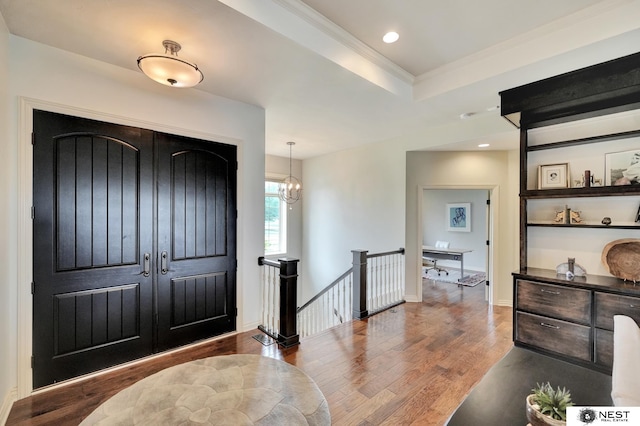 820 N 100th St, Lincoln, NE 68527 - entrance foyer featuring wood finished floors, recessed lighting, a raised ceiling, ornamental molding, and a chandelier