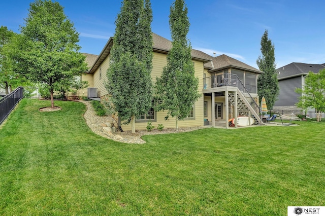 820 N 100th St, Lincoln, NE 68527 - rear view of house with a sunroom, a fenced backyard, stairway, roof with shingles, and a patio area