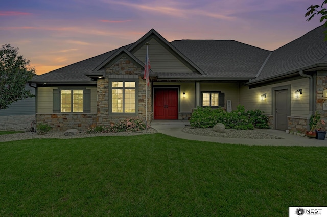 820 N 100th St, Lincoln, NE 68527 - craftsman-style house with stone siding, roof with shingles, and a front yard