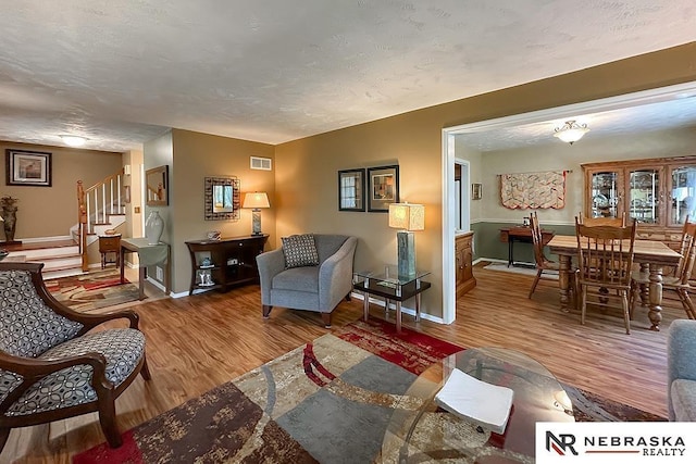 1817 Holling Dr, Omaha, NE 68144 - living area featuring wood finished floors and stairs