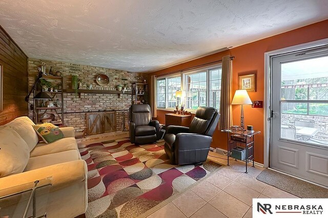 1817 Holling Dr, Omaha, NE 68144 - living area with a textured ceiling, tile patterned floors, and a brick fireplace