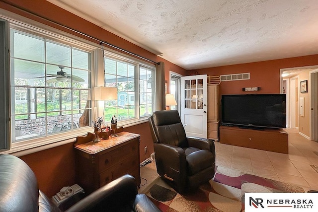 1817 Holling Dr, Omaha, NE 68144 - living area featuring a ceiling fan and a textured ceiling
