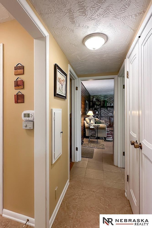 1817 Holling Dr, Omaha, NE 68144 - corridor with a textured ceiling and light tile patterned floors
