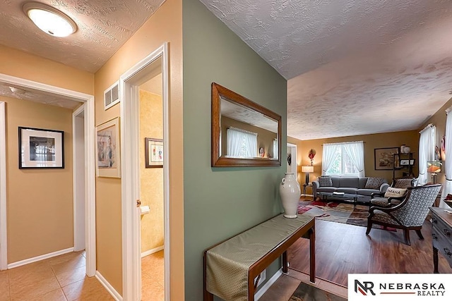 1817 Holling Dr, Omaha, NE 68144 - hall featuring a textured ceiling and baseboards