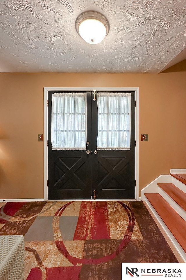1817 Holling Dr, Omaha, NE 68144 - foyer entrance featuring a textured ceiling and stairs