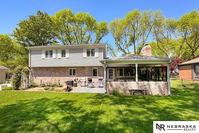 1817 Holling Dr, Omaha, NE 68144 - rear view of house with a patio area, a chimney, and brick siding