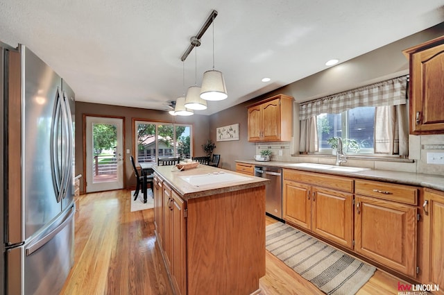 4630 Eagle Ridge Rd, Lincoln, NE 68516 - kitchen featuring stainless steel appliances, a center island, light wood-style floors, light countertops, and tasteful backsplash