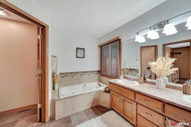 4630 Eagle Ridge Rd, Lincoln, NE 68516 - bathroom featuring a whirlpool tub, double vanity, and tile patterned floors