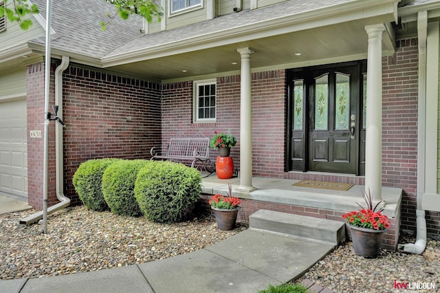 4630 Eagle Ridge Rd, Lincoln, NE 68516 - doorway to property with a porch, brick siding, and a shingled roof