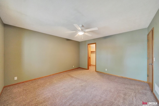 4630 Eagle Ridge Rd, Lincoln, NE 68516 - unfurnished bedroom featuring light carpet, a spacious closet, and a ceiling fan