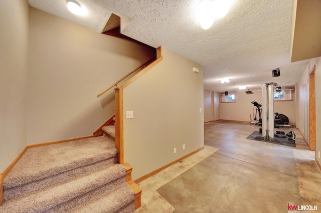 4630 Eagle Ridge Rd, Lincoln, NE 68516 - exercise room featuring a textured ceiling and baseboards
