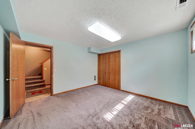 4630 Eagle Ridge Rd, Lincoln, NE 68516 - unfurnished bedroom with a textured ceiling, carpet floors, and a closet