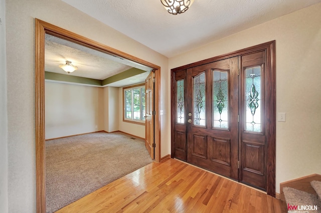 4630 Eagle Ridge Rd, Lincoln, NE 68516 - foyer featuring light wood finished floors, light colored carpet, and a textured ceiling