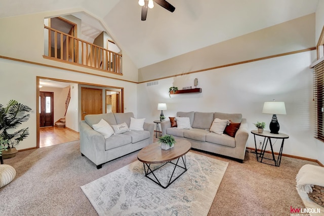 4630 Eagle Ridge Rd, Lincoln, NE 68516 - living room with carpet flooring, a ceiling fan, high vaulted ceiling, and stairs