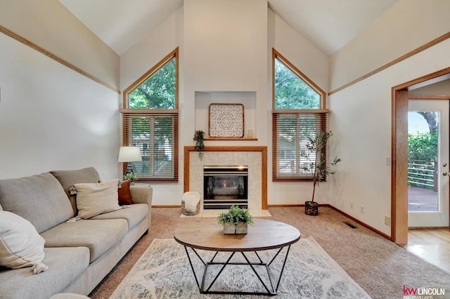 4630 Eagle Ridge Rd, Lincoln, NE 68516 - carpeted living room featuring a tiled fireplace and high vaulted ceiling