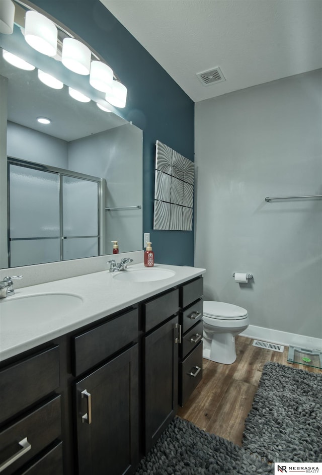 7342 S 184th St, Omaha, NE 68136 - full bath featuring wood finished floors, a stall shower, and double vanity