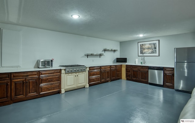 7342 S 184th St, Omaha, NE 68136 - kitchen featuring stainless steel appliances, concrete floors, light countertops, a textured ceiling, and recessed lighting