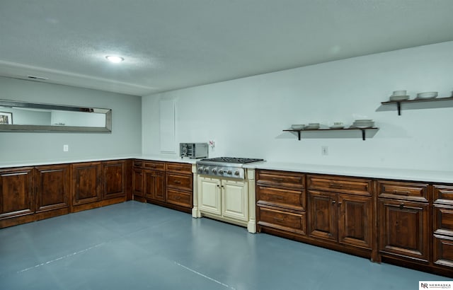 7342 S 184th St, Omaha, NE 68136 - kitchen featuring open shelves, stainless steel gas stovetop, light countertops, dark brown cabinetry, and finished concrete floors