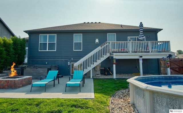 7342 S 184th St, Omaha, NE 68136 - rear view of house featuring an outdoor fire pit, stairway, a patio area, a deck, and a hot tub