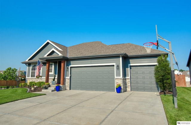 7342 S 184th St, Omaha, NE 68136 - view of front of home featuring an attached garage, concrete driveway, stone siding, and a shingled roof