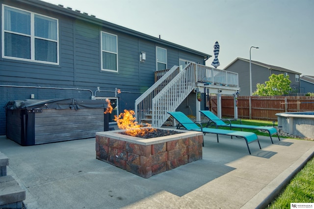 7342 S 184th St, Omaha, NE 68136 - view of patio / terrace with a fire pit, a hot tub, stairs, and a deck