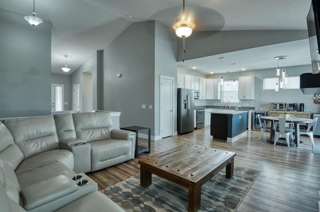 7342 S 184th St, Omaha, NE 68136 - living room featuring vaulted ceiling, ceiling fan, and light wood-type flooring