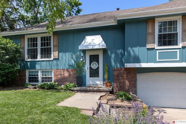 622 S 126th St, Omaha, NE 68154 - view of front of house featuring brick siding, an attached garage, a front lawn, and board and batten siding