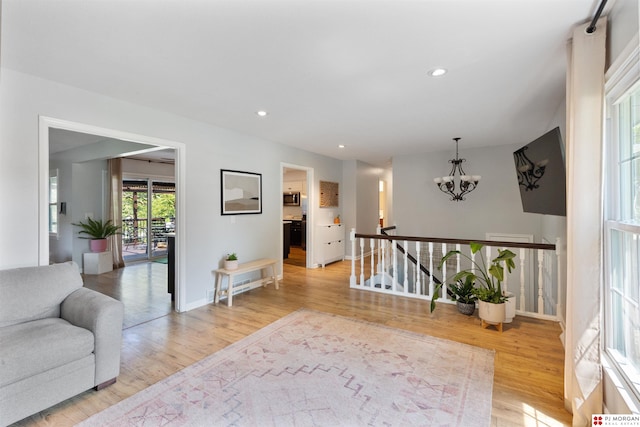 622 S 126th St, Omaha, NE 68154 - living area with light wood finished floors, a chandelier, and recessed lighting