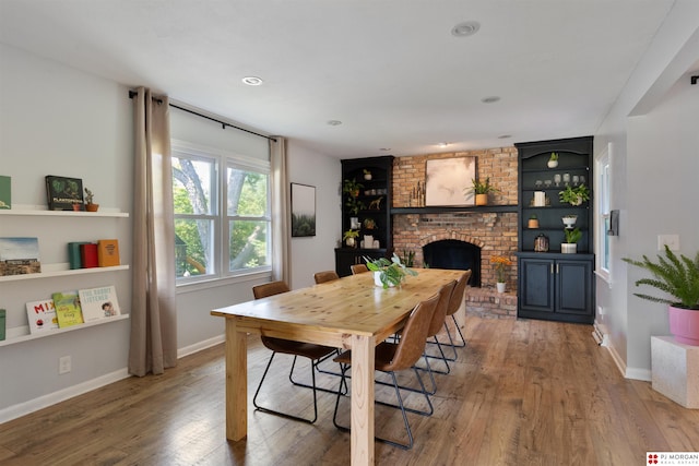 622 S 126th St, Omaha, NE 68154 - dining space featuring wood-type flooring, a fireplace, and built in features