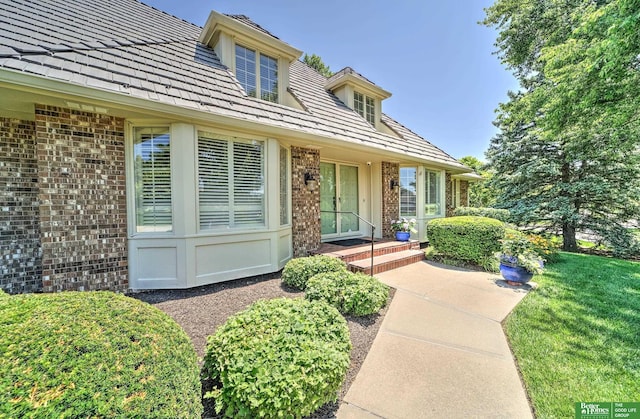 9706 Ascot Dr, Omaha, NE 68114 - property entrance featuring brick siding and a lawn