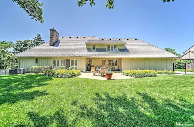 9706 Ascot Dr, Omaha, NE 68114 - back of property with board and batten siding, a chimney, and a patio