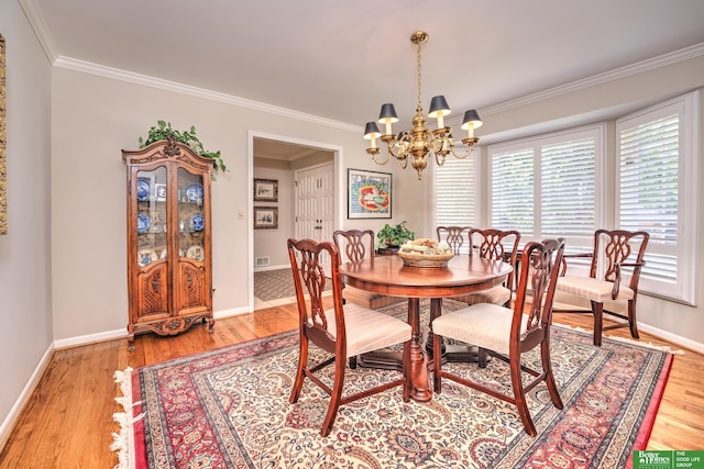 9706 Ascot Dr, Omaha, NE 68114 - dining space with crown molding, a chandelier, and light wood finished floors