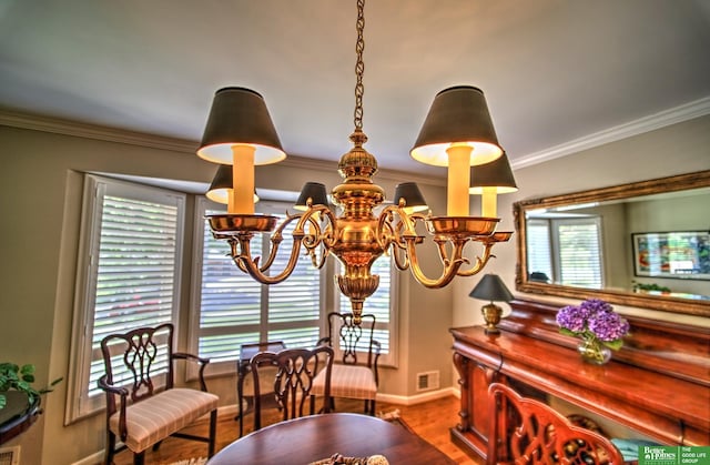 9706 Ascot Dr, Omaha, NE 68114 - dining area with a chandelier, wood finished floors, and crown molding