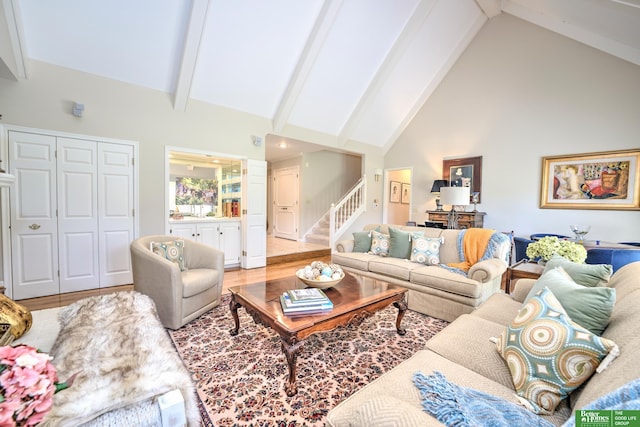 9706 Ascot Dr, Omaha, NE 68114 - living area with high vaulted ceiling, stairs, beamed ceiling, and light wood-style flooring