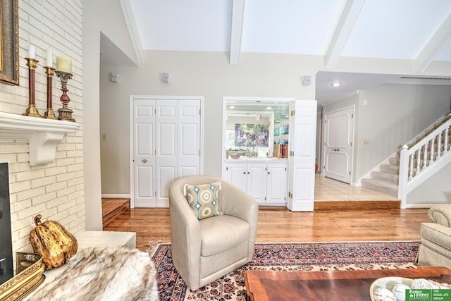 9706 Ascot Dr, Omaha, NE 68114 - living room with light wood-style flooring, stairs, and a fireplace