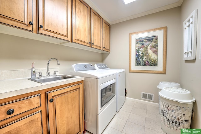 9706 Ascot Dr, Omaha, NE 68114 - laundry room with cabinet space, washer and clothes dryer, ornamental molding, and light tile patterned flooring