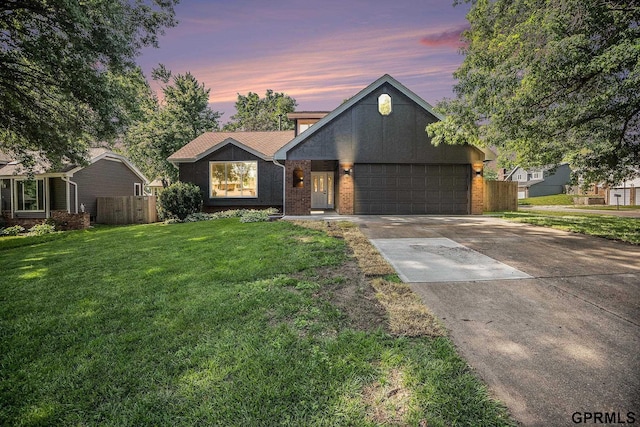 801 Redwood Ln, Papillion, NE 68046 - view of front facade with driveway, an attached garage, and brick siding