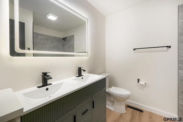 801 Redwood Ln, Papillion, NE 68046 - bathroom with wood finished floors, double vanity, and a tile shower