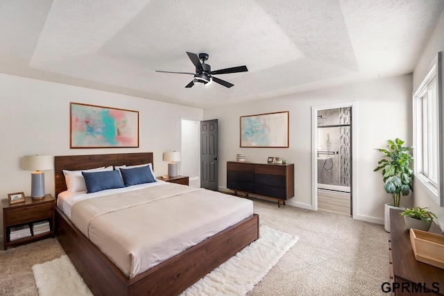 801 Redwood Ln, Papillion, NE 68046 - bedroom with light colored carpet, a textured ceiling, ensuite bathroom, ceiling fan, and a tray ceiling