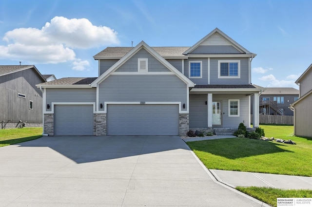 7163 N 164th St, Bennington, NE 68007 - view of front of property with concrete driveway, an attached garage, a front lawn, and stone siding