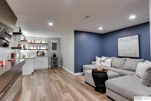7163 N 164th St, Bennington, NE 68007 - living area featuring wine cooler, a dry bar, light wood-style floors, and recessed lighting