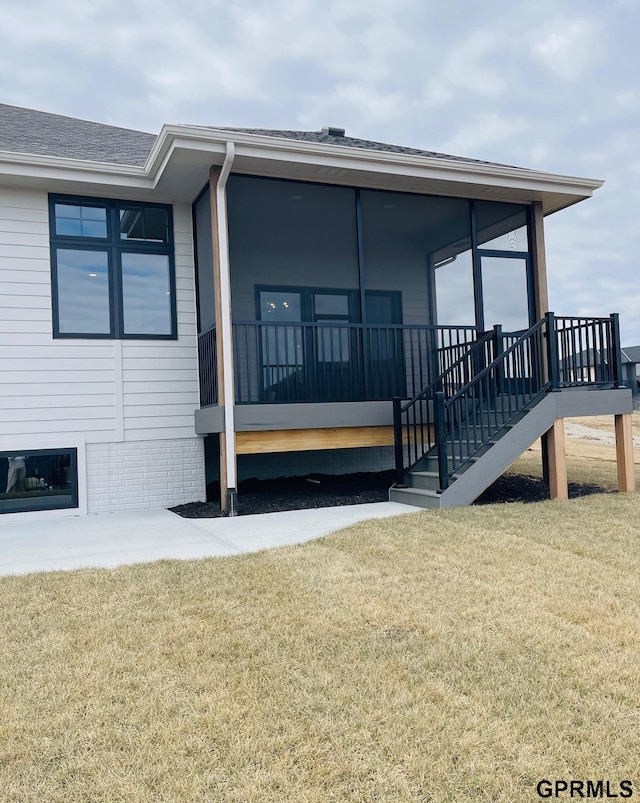 20506 Boulder St, Gretna, NE 68028 - view of home's exterior with a lawn, a sunroom, a shingled roof, and stairway